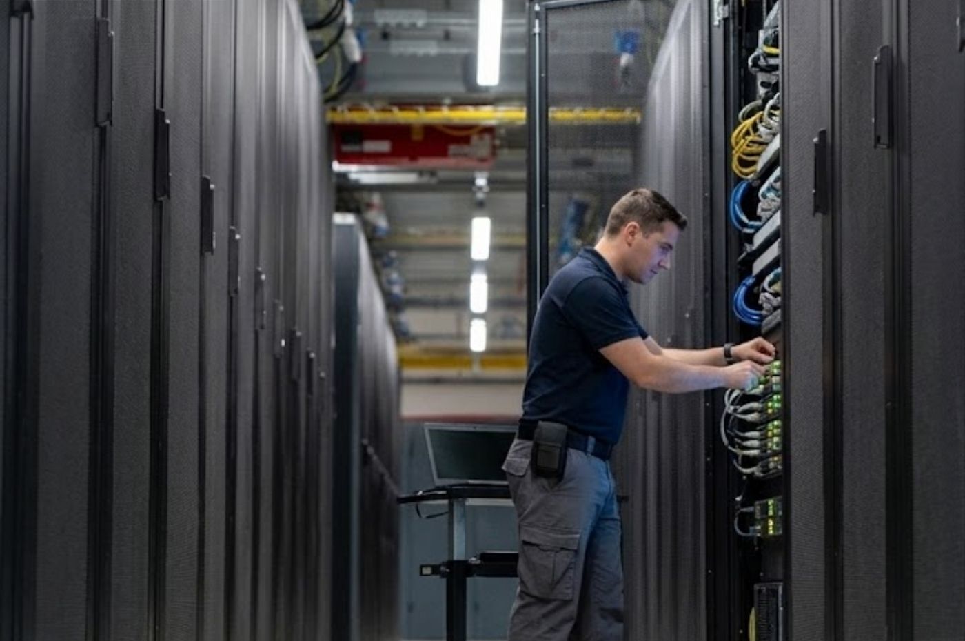 An engineer works on dedicated server in a datacenter